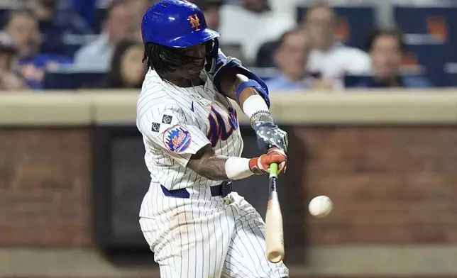 New York Mets' Luisangel Acuna hits a home run during the eighth inning of a baseball game against the Washington Nationals, Tuesday, Sept. 17, 2024, in New York. (AP Photo/Frank Franklin II)