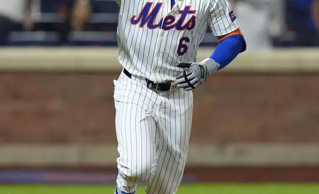 New York Mets' Starling Marte gestures as he runs to first base after hitting an RBI single during the 10th inning of a baseball game against the Washington Nationals, Monday, Sept. 16, 2024, in New York. (AP Photo/Frank Franklin II)