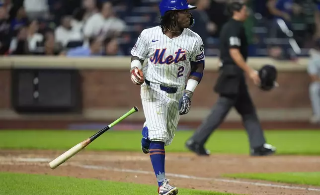 New York Mets' Luisangel Acuna tosses his bat as he runs the bases after hitting a home run during the eighth inning of a baseball game against the Washington Nationals, Tuesday, Sept. 17, 2024, in New York. (AP Photo/Frank Franklin II)