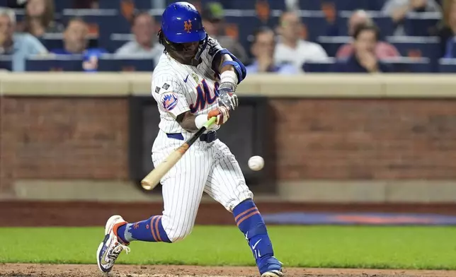 New York Mets' Luisangel Acuña hits an RBI double during the third inning of a baseball game against the Washington Nationals, Tuesday, Sept. 17, 2024, in New York. (AP Photo/Frank Franklin II)