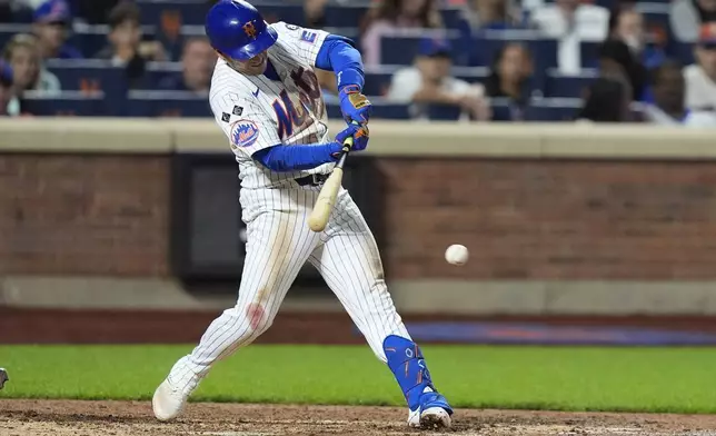 New York Mets' Jose Iglesias hits an RBI single during the eighth inning of a baseball game against the Washington Nationals, Monday, Sept. 16, 2024, in New York. (AP Photo/Frank Franklin II)