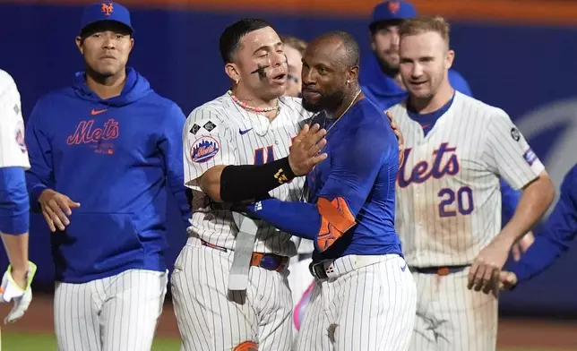 New York Mets' Starling Marte, front right, and Francisco Alvarez, center left, celebrate with teammates after a baseball game against the Washington Nationals, Monday, Sept. 16, 2024, in New York. (AP Photo/Frank Franklin II)