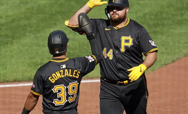 Pittsburgh Pirates' Rowdy Tellez (44) celebrates with Nick Gonzales after hitting a two-run home run off Washington Nationals relief pitcher Jacob Barnes during the seventh inning of the first baseball game of a split doubleheader in Pittsburgh, Saturday, Sept. 7, 2024. (AP Photo/Gene J. Puskar)