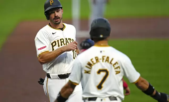 Pittsburgh Pirates' Bryan Reynolds, left, and Isiah Kiner-Falefa (7) score on a single by Nick Gonzales off Washington Nationals starting pitcher Jake Irvin during the second inning of a baseball game in Pittsburgh, Thursday, Sept. 5, 2024. (AP Photo/Gene J. Puskar)