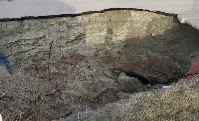 This photo taken April 27, 2022, by Tonya Junker shows a sinkhole in the Hideaway Hills neighborhood near Rapid City, S.D. (Tonya Junker via AP)