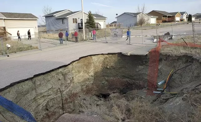 This photo taken April 27, 2022, by Tonya Junker shows a sinkhole in the Hideaway Hills neighborhood near Rapid City, S.D. (Tonya Junker via AP)