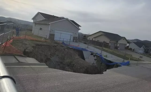 This photo taken April 27, 2022, by Tonya Junker shows a sinkhole in the Hideaway Hills neighborhood near Rapid City, S.D. (Tonya Junker via AP)