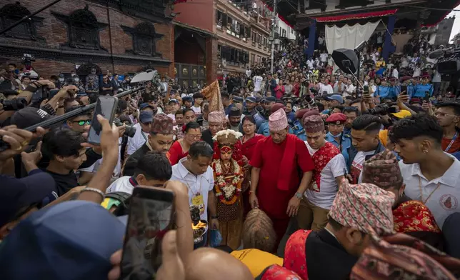 Living goddess Kumari is directed towards a chariot during Indra Jatra, a festival that marks the end of the rainy season in Kathmandu, Nepal, Tuesday, Sept. 17, 2024. (AP Photo/Niranjan Shrestha)