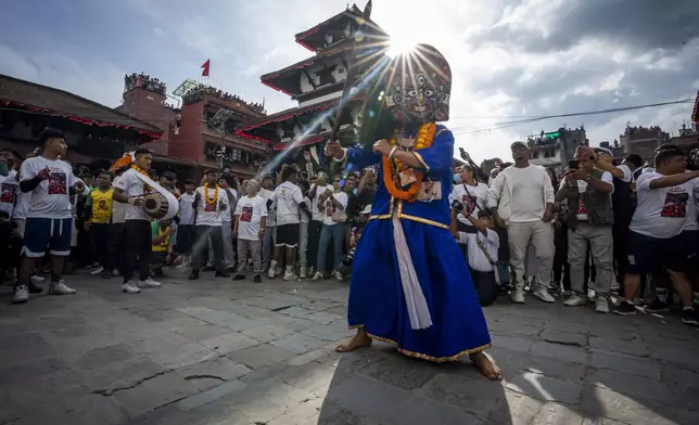 A masked dancer performs during Indra Jatra, a festival that marks the end of the rainy season in Kathmandu, Nepal, Tuesday, Sept. 17, 2024. (AP Photo/Niranjan Shrestha)