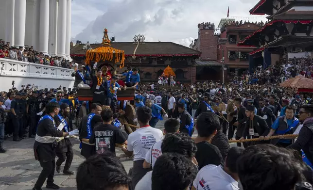 Devotees pull the chariot during Indra Jatra, a festival that marks the end of the rainy season in Kathmandu, Nepal, Tuesday, Sept. 17, 2024. (AP Photo/Niranjan Shrestha)