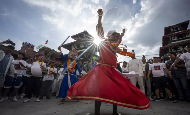 Masked dancers perform during Indra Jatra, a festival that marks the end of the rainy season in Kathmandu, Nepal, Tuesday, Sept. 17, 2024. (AP Photo/Niranjan Shrestha)