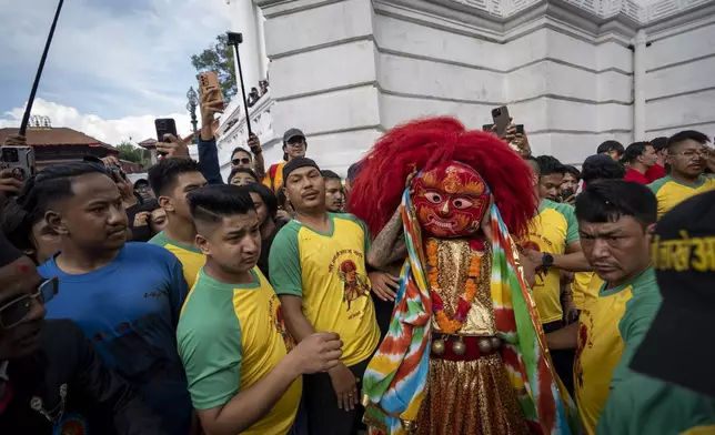 The Lakhe, a demon adored for divine might, performs during Indra Jatra, a festival that marks the end of the rainy season in Kathmandu, Nepal, Tuesday, Sept. 17, 2024. (AP Photo/Niranjan Shrestha)