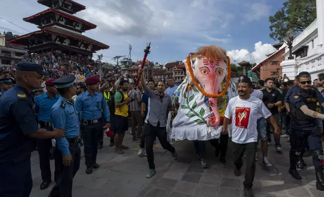 Devotees perform a traditional elephant dance during Indra Jatra, a festival that marks the end of the rainy season in Kathmandu, Nepal, Tuesday, Sept. 17, 2024. (AP Photo/Niranjan Shrestha)