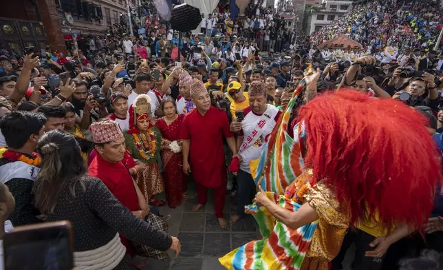 Living god Ganesh is directed towards a chariot during Indra Jatra, a festival that marks the end of the rainy season in Kathmandu, Nepal, Tuesday, Sept. 17, 2024. (AP Photo/Niranjan Shrestha)