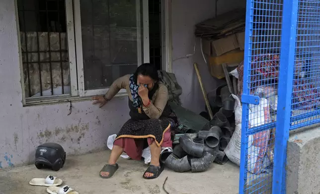 A woman cries after she lost her home due to floods caused by heavy rains in Kathmandu, Nepal, Saturday, Sept. 28, 2024. (AP Photo/Gopen Rai)