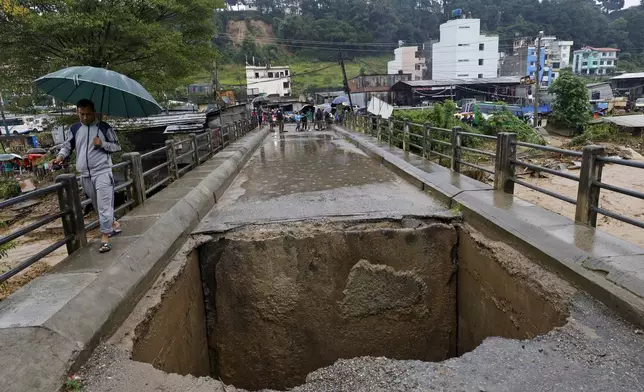 A bridge over Bagmati River lies damaged due to floods caused by heavy rains in Kathmandu, Nepal, Saturday, Sept. 28, 2024. (AP Photo/Gopen Rai)