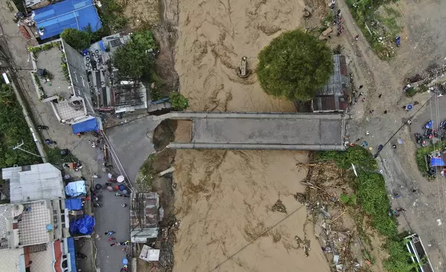 In this aerial image of the Kathmandu valley, Bagmati River is seen in flood due to heavy rains in Kathmandu, Nepal, Saturday, Sept. 28, 2024. (AP Photo/Gopen Rai)