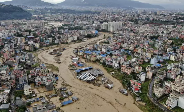 In this aerial image of the Kathmandu valley, Bagmati River is seen in flood due to heavy rains in Kathmandu, Nepal, Saturday, Sept. 28, 2024. (AP Photo/Gopen Rai)