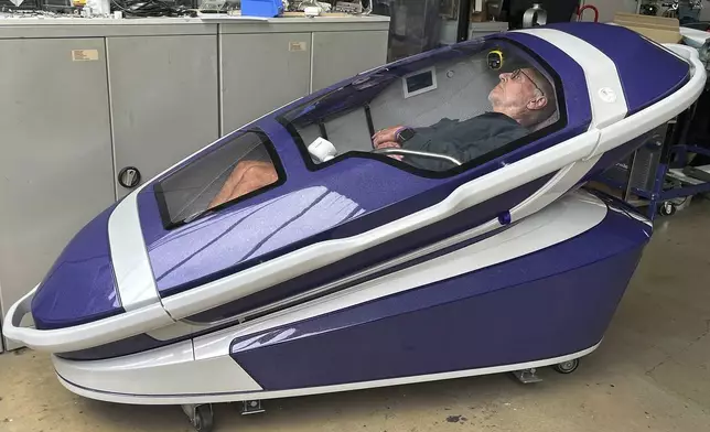 Philip Nitschke is seen inside a 'suicide pod' known as 'The Sarco' in Rotterdam, The Netherlands, July 8, 2024. (AP Photo/Ahmad Seir)