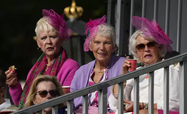 Three women wait for Dutch King Willem-Alexander and Queen Maxima to arrive, prior to the King outlining the new government's policy plans and budget for the coming year in The Hague, Netherlands, Tuesday, Sept. 17, 2024. (AP Photo/Peter Dejong)