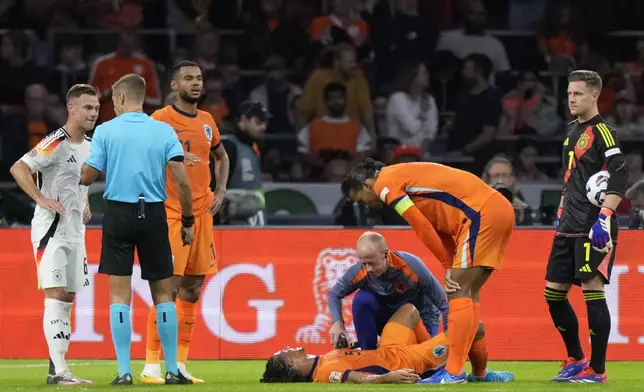 Nathan Ake of the Netherlands lies injured dured during the UEFA Nations League soccer match between Netherlands and Germany in Amsterdam, Netherlands, on Tuesday, Sept. 10, 2024. (AP Photo/Peter Dejong)