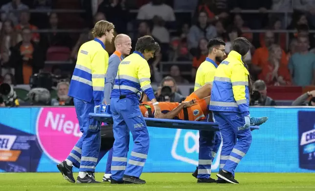 Nathan Ake of the Netherlands is taken off the pitch during the UEFA Nations League soccer match between Netherlands and Germany in Amsterdam, Netherlands, on Tuesday, Sept. 10, 2024. (AP Photo/Peter Dejong)