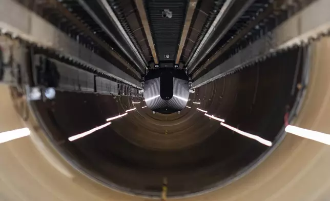 A test vehicle levitated by magnetic fields zips through a depressurized tube in a testing ground for a high-speed transit system during a press tour of a European test center for hyperloop transportation technology in Veendam, northern Netherlands, Friday, Sept. 6, 2024. (AP Photo/Peter Dejong)