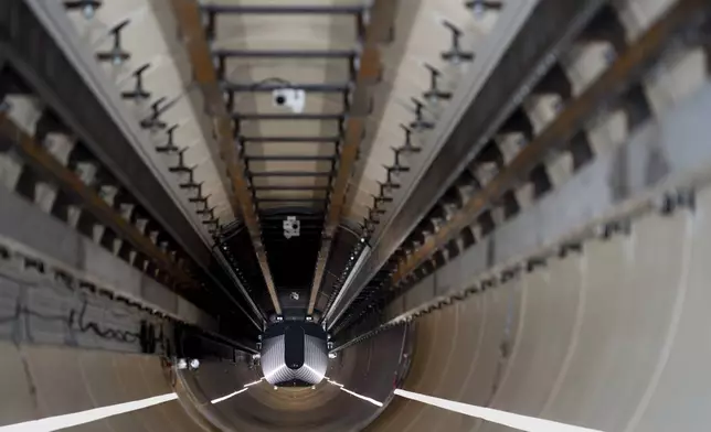 A test vehicle levitated by magnetic fields zips through a depressurized tube in a testing ground for a high-speed transit system during a press tour of a European test center for hyperloop transportation technology in Veendam, northern Netherlands, Friday, Sept. 6, 2024. (AP Photo/Peter Dejong)