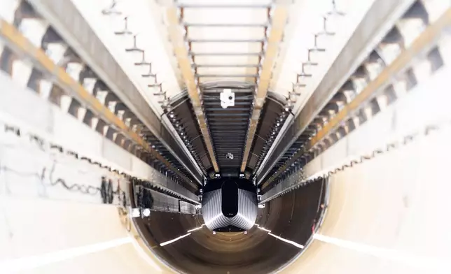 A test vehicle levitated by magnetic fields zips through a depressurized tube in a testing ground for a high-speed transit system during a press tour of a European test center for hyperloop transportation technology in Veendam, northern Netherlands, Friday, Sept. 6, 2024. (AP Photo/Peter Dejong)