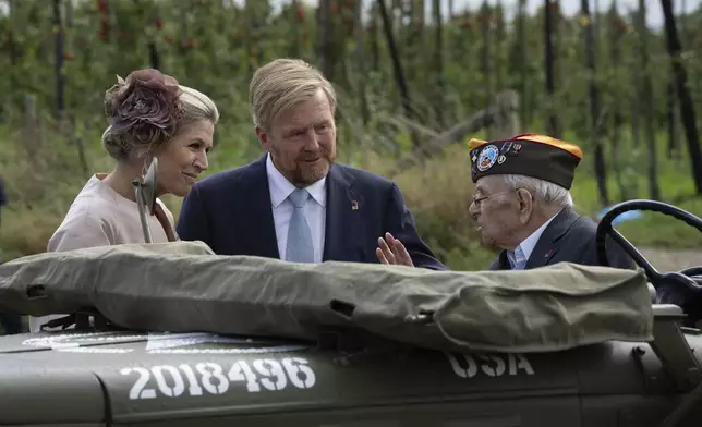 World War II veteran Kenneth Thayer is greeted by Dutch King Willem-Alexander and Queen Maxima before the royals joined Thayer in the jeep during a ceremony marking the 80th anniversary of the liberation of the south of the Netherlands in Mesch, Thursday, Sept. 12, 2024. (AP Photo/Peter Dejong, Pool)