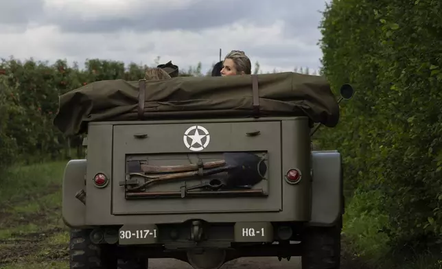 Dutch Queen Maxima looks back from a jeep during a ceremony marking the 80th anniversary of the liberation of the south of the Netherlands in Mesch, Thursday, Sept. 12, 2024. (AP Photo/Peter Dejong, Pool)