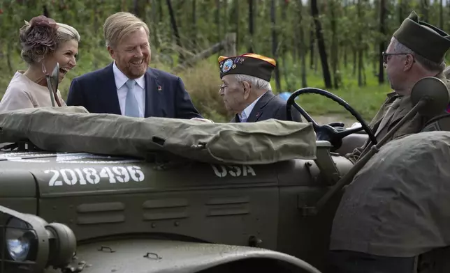 World War II veteran Kenneth Thayer is greeted by Dutch King Willem-Alexander and Queen Maxima before the royals joined Thayer in the jeep during a ceremony marking the 80th anniversary of the liberation of the south of the Netherlands in Mesch, Thursday, Sept. 12, 2024. (AP Photo/Peter Dejong, Pool)