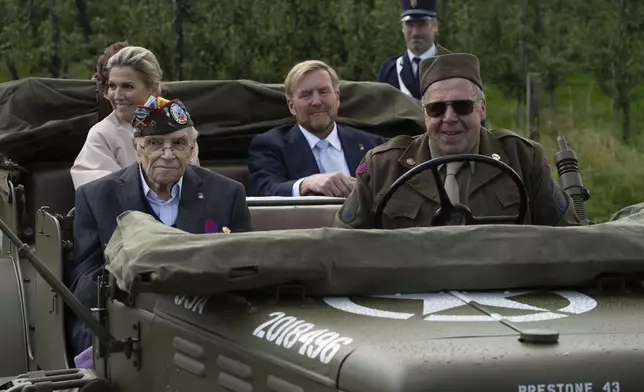 World War II veteran Kenneth Thayer, Dutch King Willem-Alexander and Queen Maxima drive in a jeep during a ceremony marking the 80th anniversary of the liberation of the south of the Netherlands in Mesch, Thursday, Sept. 12, 2024. (AP Photo/Peter Dejong, Pool)