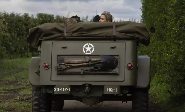 Dutch Queen Maxima looks back from a jeep during a ceremony marking the 80th anniversary of the liberation of the south of the Netherlands in Mesch, Thursday, Sept. 12, 2024. (AP Photo/Peter Dejong, Pool)