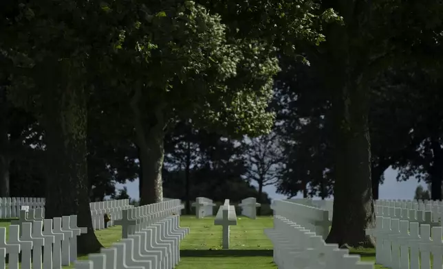 Eighty years after the liberation of the south of the Netherlands the sun illuminates some of the 8,288 crosses and Star of David headstones at the Netherlands American Cemetery in Margraten, southern Netherlands, on Wednesday, Sept. 11, 2024. (AP Photo/Peter Dejong)