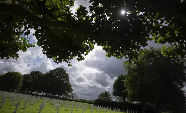 Eighty years after the liberation of the south of the Netherlands the sun illuminates some of the 8,288 crosses and Star of David headstones at the Netherlands American Cemetery in Margraten, southern Netherlands, on Wednesday, Sept. 11, 2024. (AP Photo/Peter Dejong)