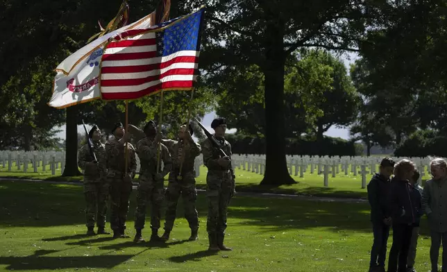 Flag bearers of the the 101st Airborne Division, known as Screaming Eagles, out of Fort Campbell, Kentucky, rehearse for a commemoration eighty years after the liberation of the south of the Netherlands at the Netherlands American Cemetery in Margraten, southern Netherlands, on Wednesday, Sept. 11, 2024. (AP Photo/Peter Dejong)