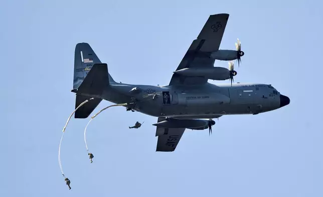 Parachutists jump over Ginkel Heath Netherlands, Saturday, Sept. 21, 2024, to mark the 80th anniversary of an audacious by unsuccessful World War II mission codenamed Market Garden to take key bridges in the Netherlands. (AP Photo/Phil Nijhuis)