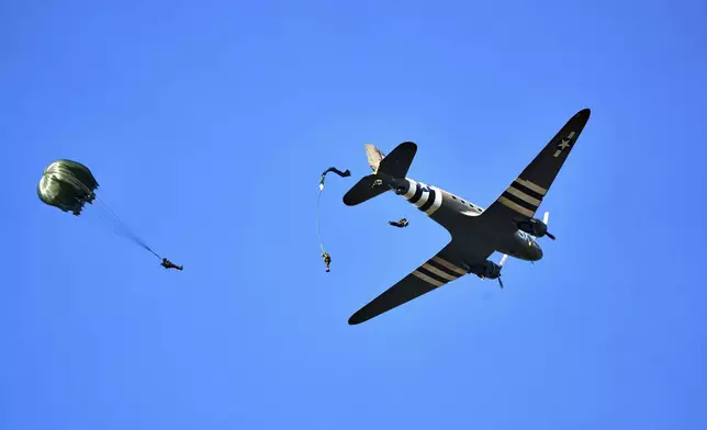 Parachutists jump over Ginkel Heath Netherlands, Saturday, Sept. 21, 2024, to mark the 80th anniversary of an audacious by unsuccessful World War II mission codenamed Market Garden to take key bridges in the Netherlands. (AP Photo/Phil Nijhuis)