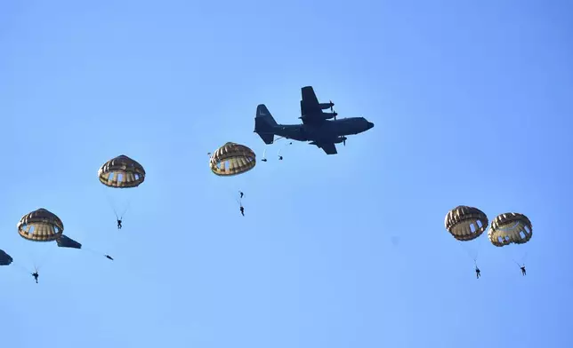 Parachutists jump over Ginkel Heath Netherlands, Saturday, Sept. 21, 2024, to mark the 80th anniversary of an audacious by unsuccessful World War II mission codenamed Market Garden to take key bridges in the Netherlands. (AP Photo/Phil Nijhuis)