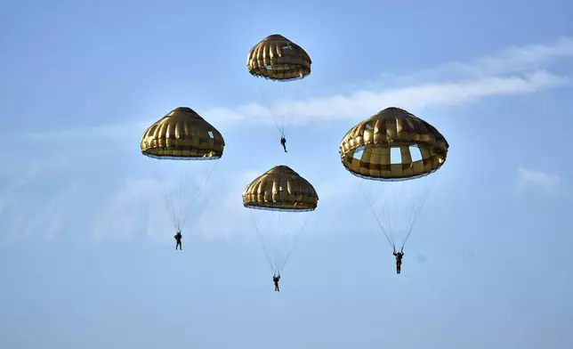 Parachutists jump over Ginkel Heath Netherlands, Saturday, Sept. 21, 2024, to mark the 80th anniversary of an audacious by unsuccessful World War II mission codenamed Market Garden to take key bridges in the Netherlands. (AP Photo/Phil Nijhuis)