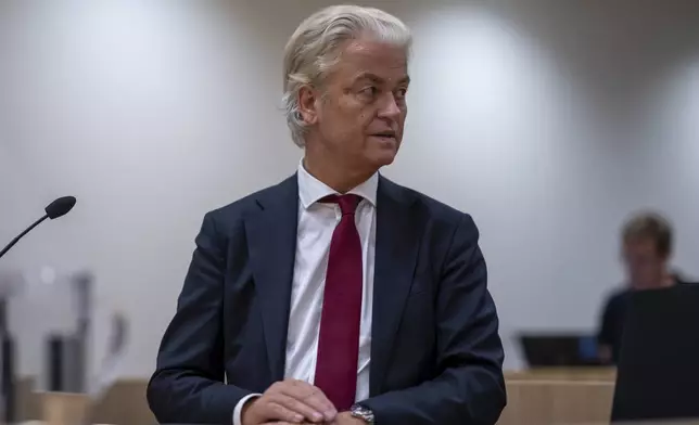 Anti-Islam lawmaker Geert Wilders takes his seat at the high security court at Schiphol, near Amsterdam, Netherlands, Monday, Sept. 2, 2024, where two Pakistani men go on trial, likely in their absence, on charges of threatening anti-Islam lawmaker Wilders, whose Party for Freedom won national elections last year. (AP Photo/Peter Dejong)