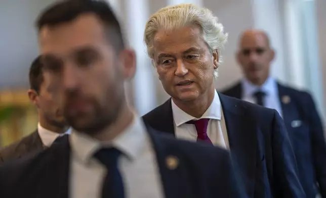 Anti-Islam lawmaker Geert Wilders, surrounded by his security detail, arrives at the high security court at Schiphol, near Amsterdam, Netherlands, Monday, Sept. 2, 2024, where two Pakistani men go on trial, likely in their absence, on charges of threatening anti-Islam lawmaker Wilders, whose Party for Freedom won national elections last year. (AP Photo/Peter Dejong)