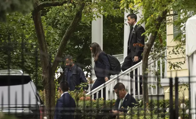 People exit Gracie Mansion, the official residence of New York City Mayor Eric Adams, Thursday, Sept. 26, 2024, in New York. (AP Photo/Yuki Iwamura)