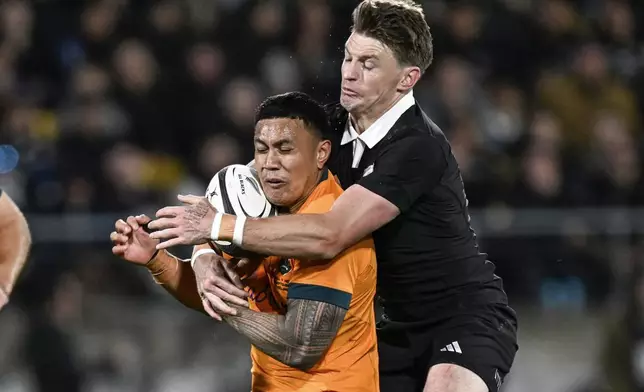 Australia's Len Ikitau is tackled by New Zealand's Beauden Barrett, right, during their Rugby Championship match between the All Blacks and the Wallabies in Wellington, New Zealand, Saturday, Sept. 28, 2024.(Andrew Cornaga/Photosport via AP)