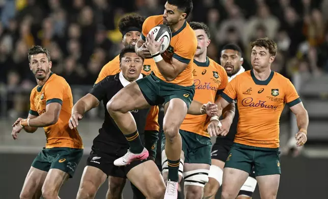 Australia's Tom Wright takes the ball during their Rugby Championship match between the All Blacks and the Wallabies in Wellington, New Zealand, Saturday, Sept. 28, 2024.(Andrew Cornaga/Photosport via AP)