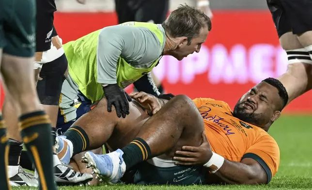 Australia's Taniela Tupou reacts as he is attended to by a trainer during their Rugby Championship match between the All Blacks and the Wallabies in Wellington, New Zealand, Saturday, Sept. 28, 2024.(Andrew Cornaga/Photosport via AP)