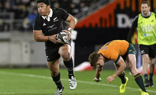 New Zealand's Caleb Clarke runs past Australia's Andrew Kellaway during their Rugby Championship match between the All Blacks and the Wallabies in Wellington, New Zealand, Saturday, Sept. 28, 2024.(Andrew Cornaga/Photosport via AP)