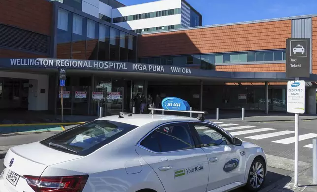 A taxi waits at a stand outside the Wellington Regional Hospital, written in English and Maori languages as New Zealand celebrates its annual Maori language week in Wellington, New Zealand, Wednesday, Sept. 18, 2024. (AP Photo/Charlotte GrahamMcLay)