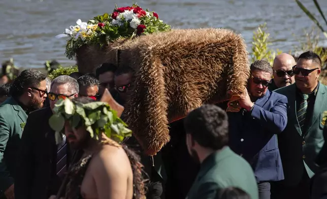 The coffin with the body of New Zealand's Maori King, Kiingi Tuheitia Pootatau Te Wherowhero VII, is carried up Taupiri Mountain for burial in Ngaruawahia, New Zealand, Thursday, Sept. 5, 2024. (AP Photo/Alan Gibson)